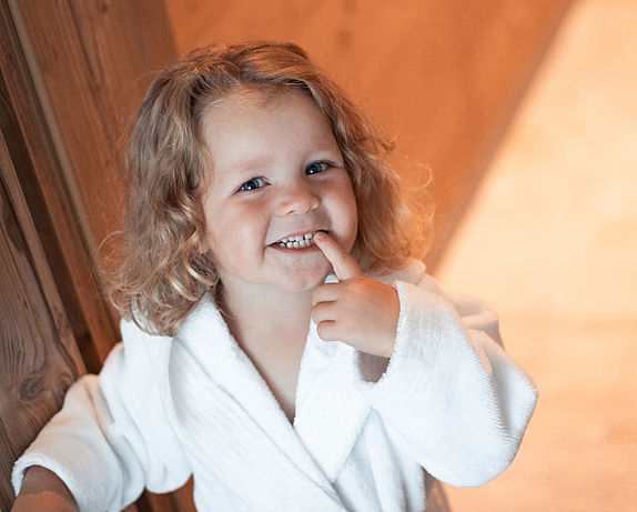 Girl in bathrobe smiles