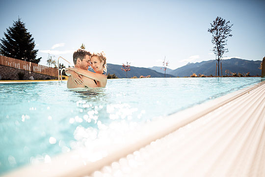 Couple hugging in the swimming pool